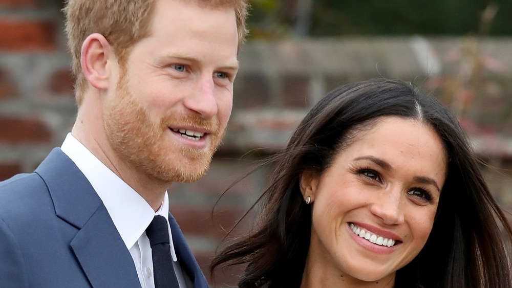 Prince Harry and actress Meghan Markle during an official photocall to announce their engagement at The Sunken Gardens at Kensington Palace on November 27, 2017