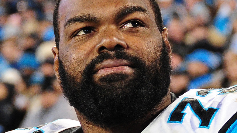 Michael Oher looking upward on the field