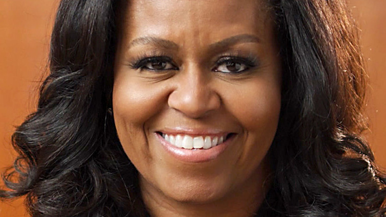 Michelle Obama smiles with her hair down