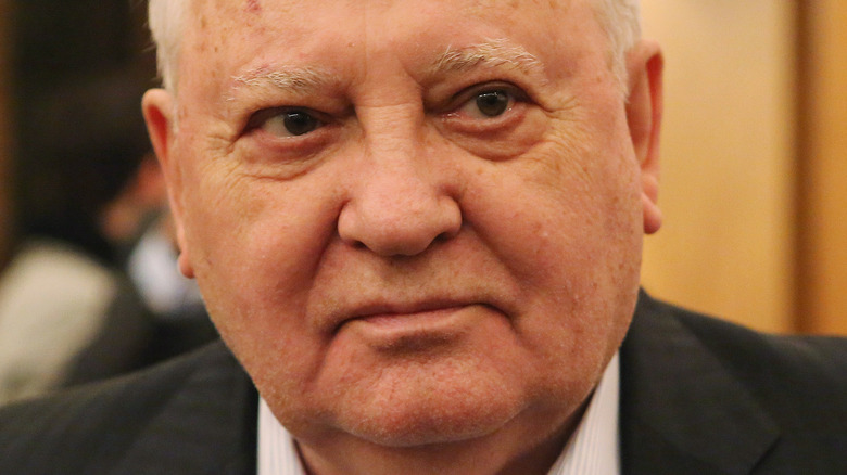 Mikhail Gorbachev poses in a suit