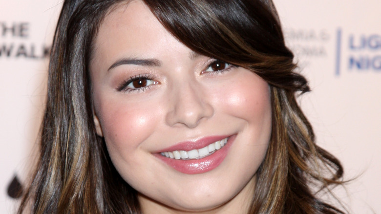 Miranda Cosgrove smiles on the red carpet