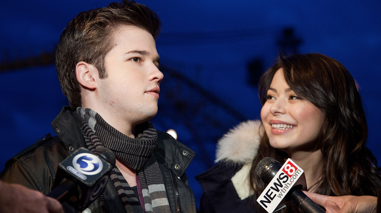 Nathan Kress reacts alongside Miranda Cosgrove at an event