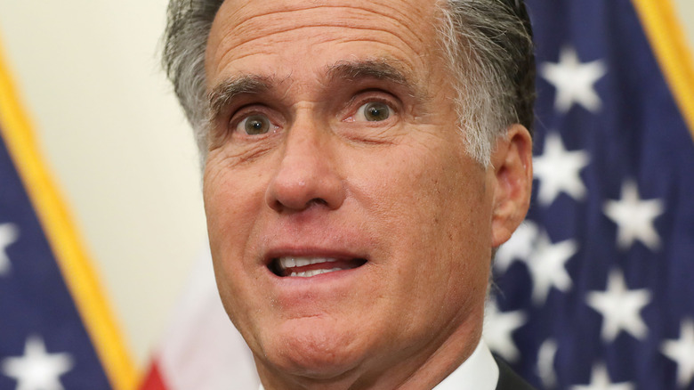 Sen. Mitt Romney (R-UT) in front of flag during news conference at the U.S. Capitol 2019