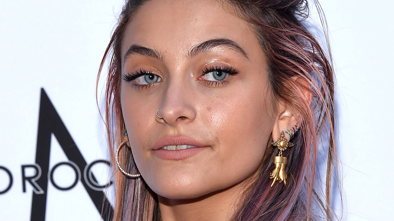 Paris Jackson poses with pink hair.