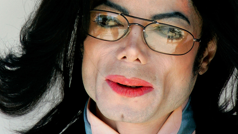 Michael Jackson wearing glasses and red lipstick