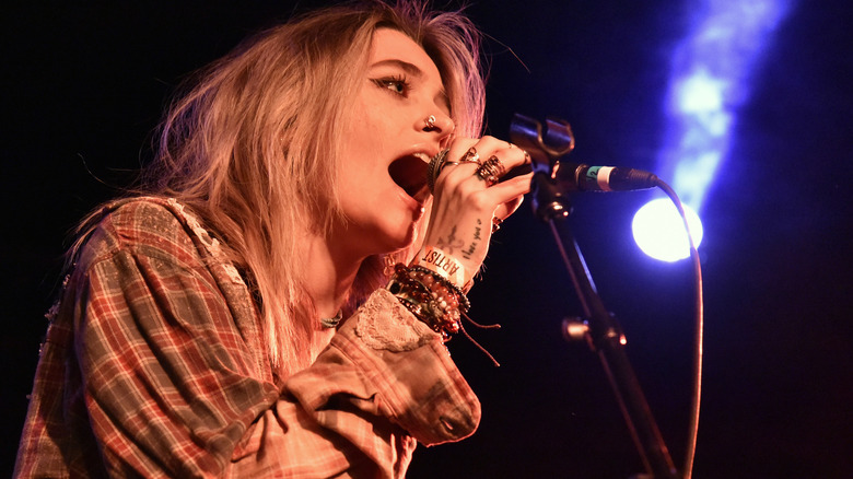 Paris Jackson singing into microphone