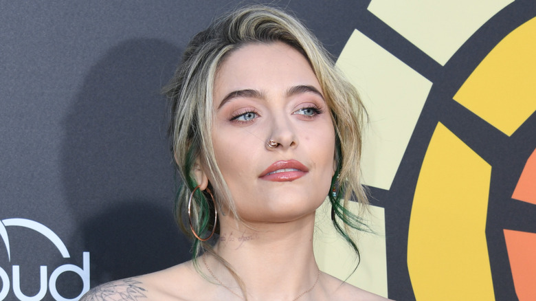 Paris Jackson looking up against media wall