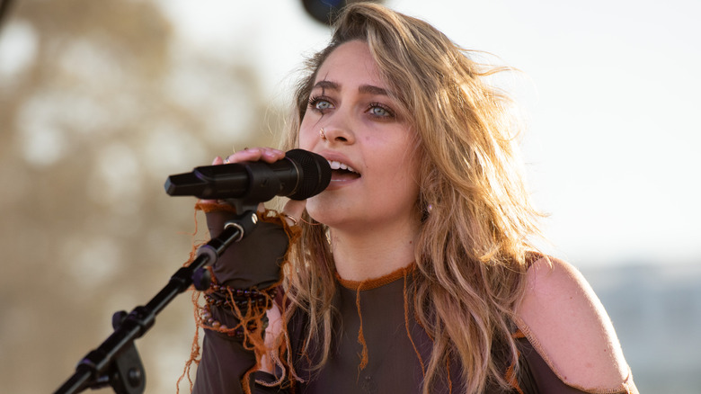 Paris Jackson singing into microphone