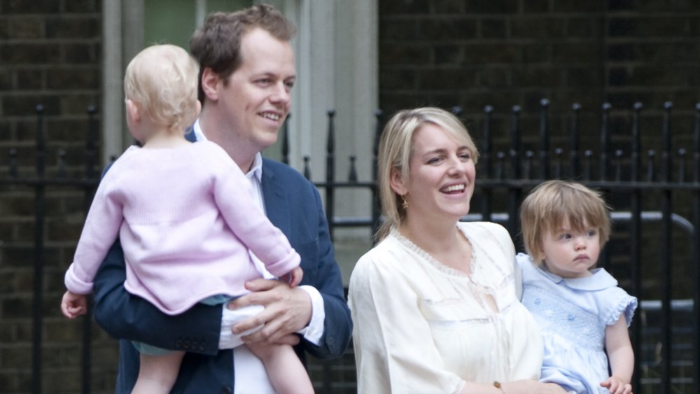 Tom Parker Bowles holding daughter Lola and Laura Lopes holding daughter Eliza