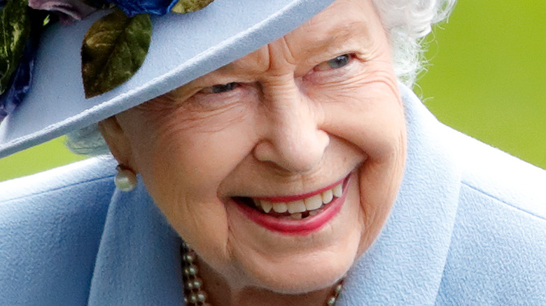 Queen Elizabeth II smiles for the camera in 2019