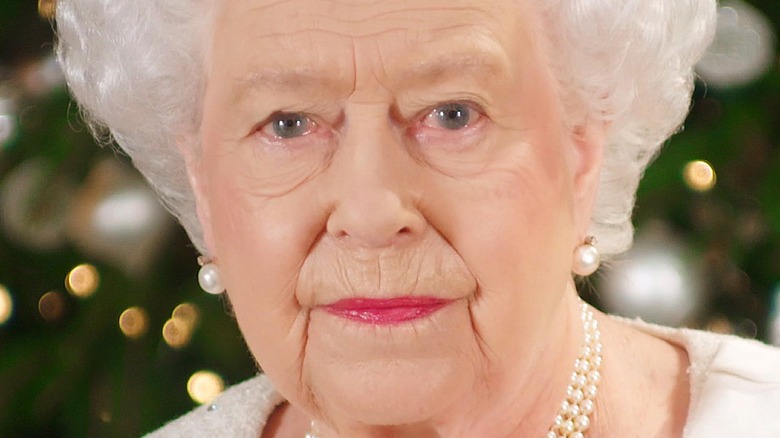 Queen Elizabeth purses her lips during a photo call