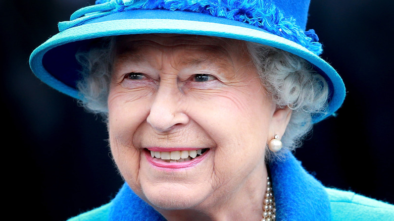 Queen Elizabeth, 2015 photo, smiling and wearing a hat