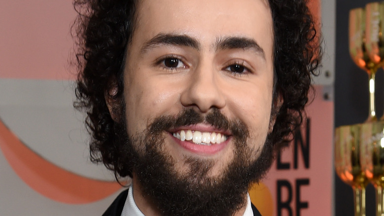 Ramy Youssef posing with an award