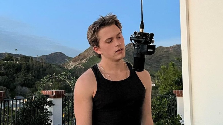 Deacon Phillippe singing into a microphone