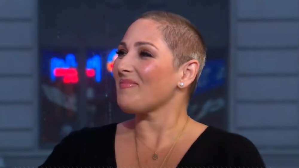 Ricki Lake with a shaved head and smiling