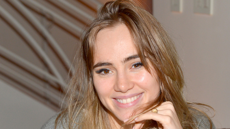 Robert Pattinson and Suki Waterhouse walk on street