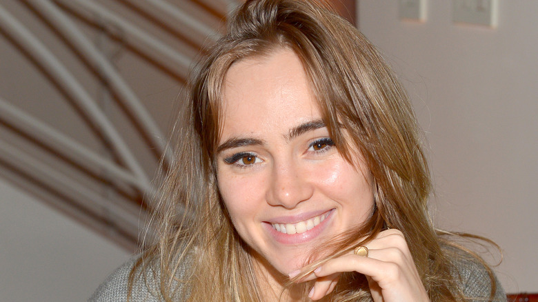 Robert Pattinson and Suki Waterhouse walk on street