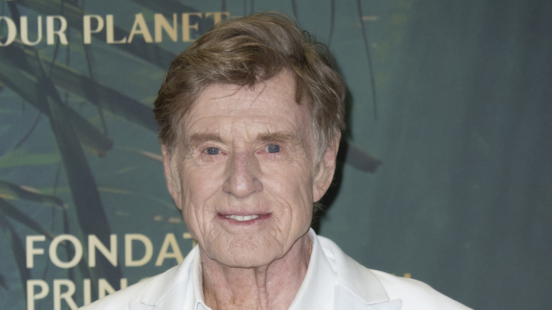 Robert Redford smiles is a white suit.