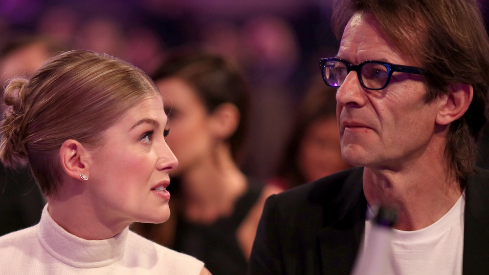 Rosamund Pike looks at her boyfriend, Robie Uniacke