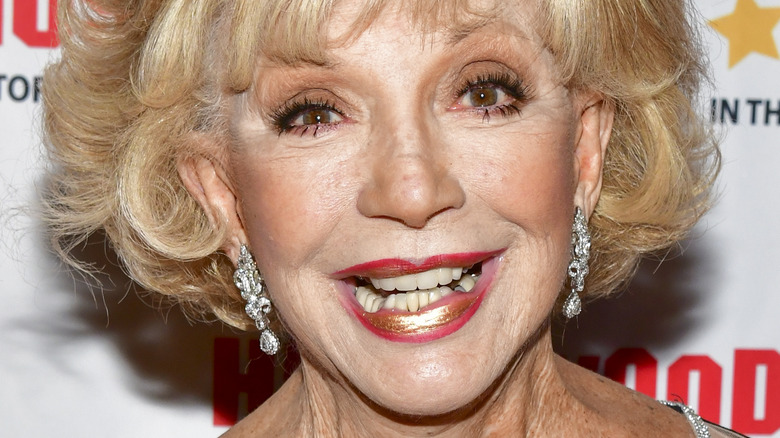 Ruta Lee poses in silver earrings