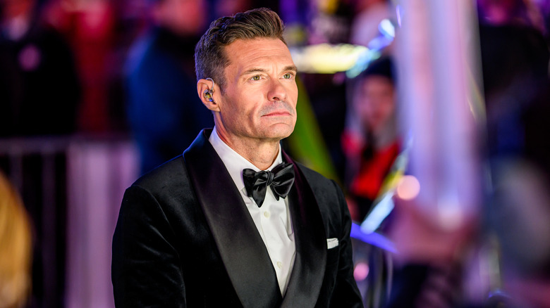 Ryan Seacrest looking out into the distance.