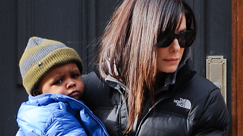 Sandra Bullock holding her son Louis