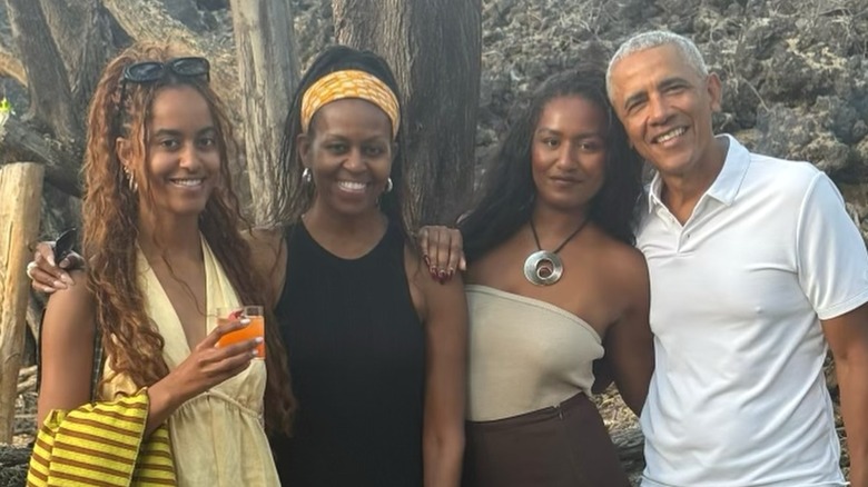 Sporting a graduation cap and simple makeup, Sasha Obama pastes a wide smile.