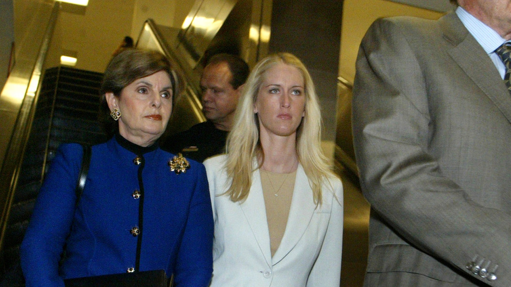 Gloria Allred and Amber Frey walking