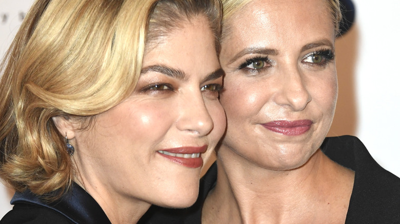 Selma Blair, Sarah Michelle Gellar with faces pressed together