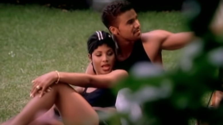 Toni Braxton, Shemar Moore, both sitting on grass