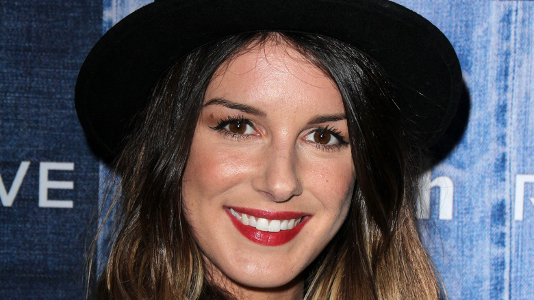 Shenae Grimes wearing a big hat