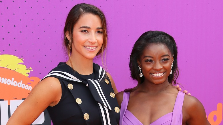 Aly Raisman and Simone Biles posing on the red carpet