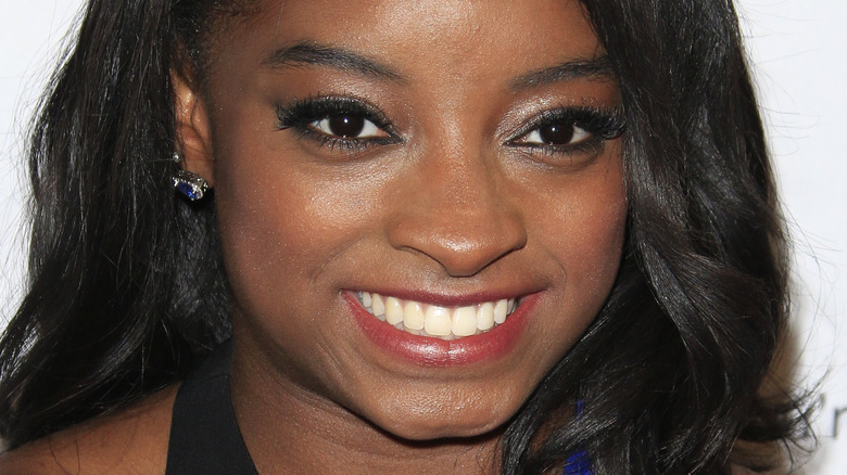 Simone Biles smiling on the red carpet