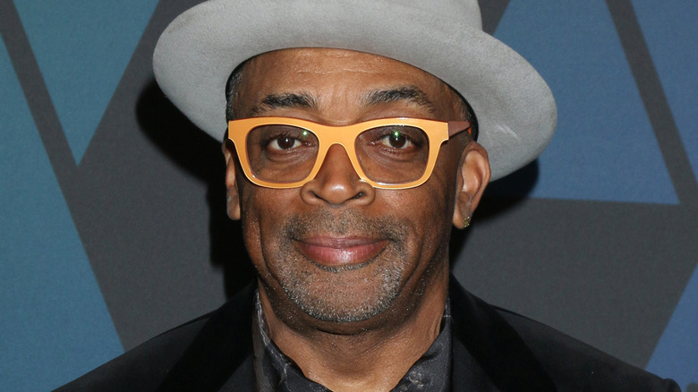 Spike Lee wearing a gray fedora