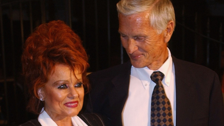 Tammy Faye Bakker holding a copy of her memoir