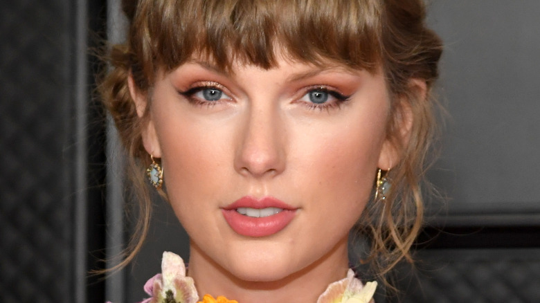 Taylor Swift looks at camera