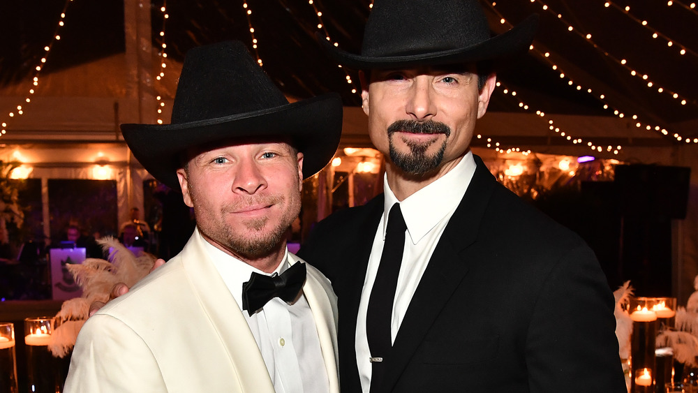 Brian Littrell and Kevin Richardson pose together in black cowboy hats