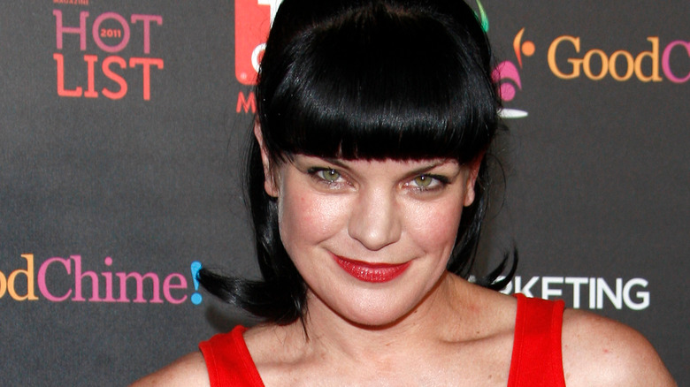 Pauley Perrette smiling in red tank top