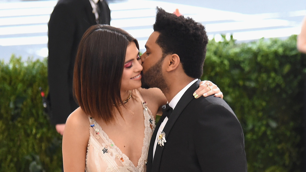 Selena Gomez and The Weeknd posing