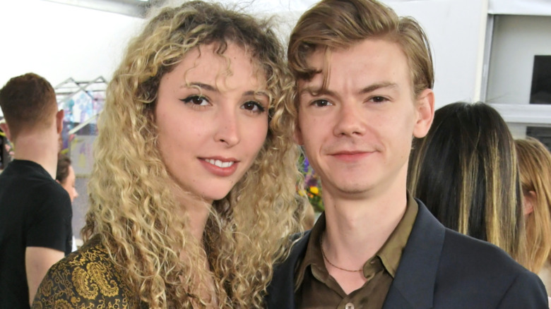 Gzi Wisdom and Thomas Brodie-Sangster at a party