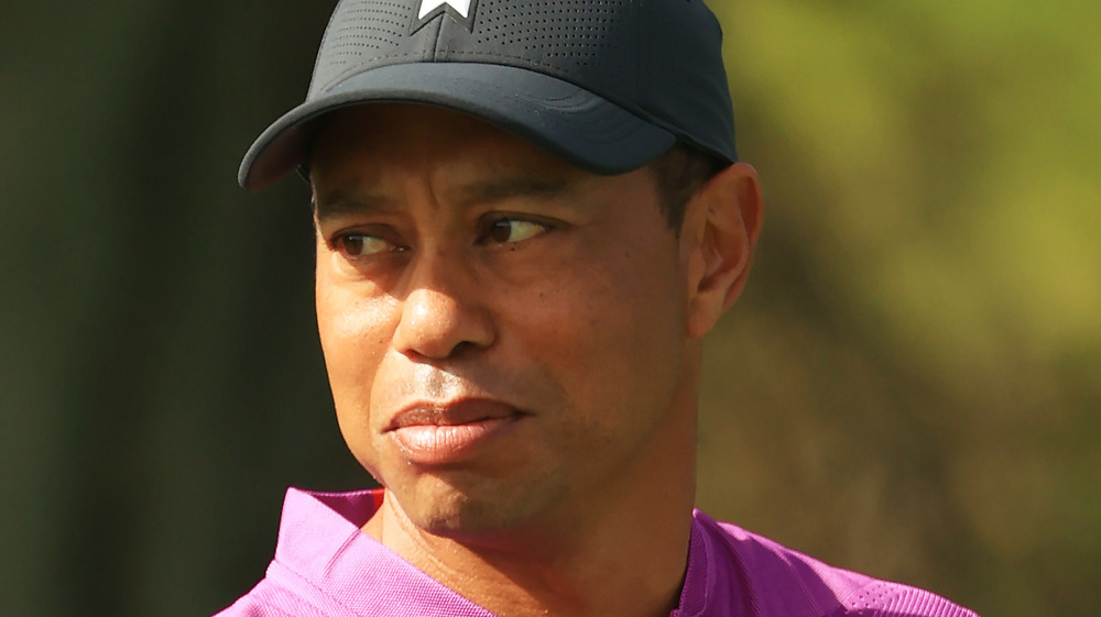 Tiger Woods looks at his put while in competition