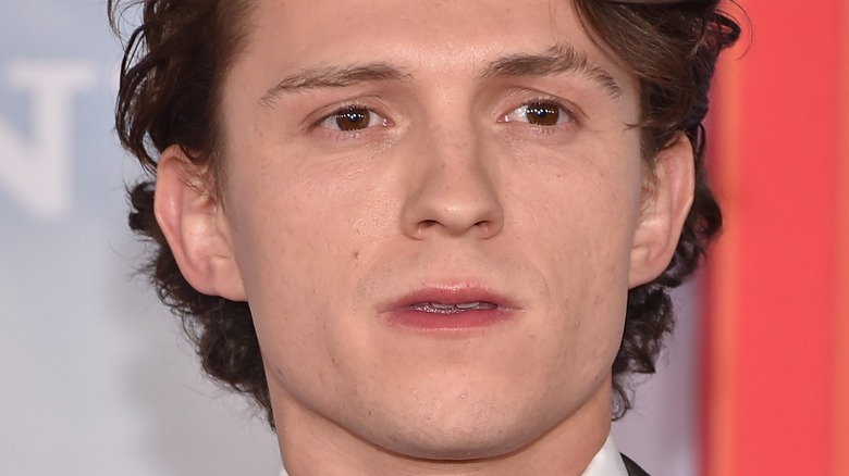 Tom holland looking away from camera mouth open