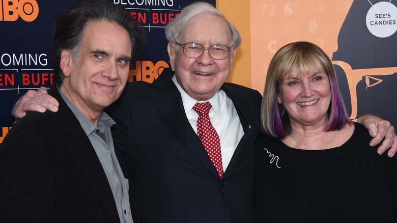 Peter, Warren, and Susie Buffett posing together