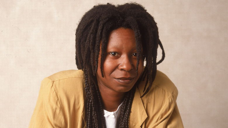 Whoopi Goldberg leaning on a chair in 1988.