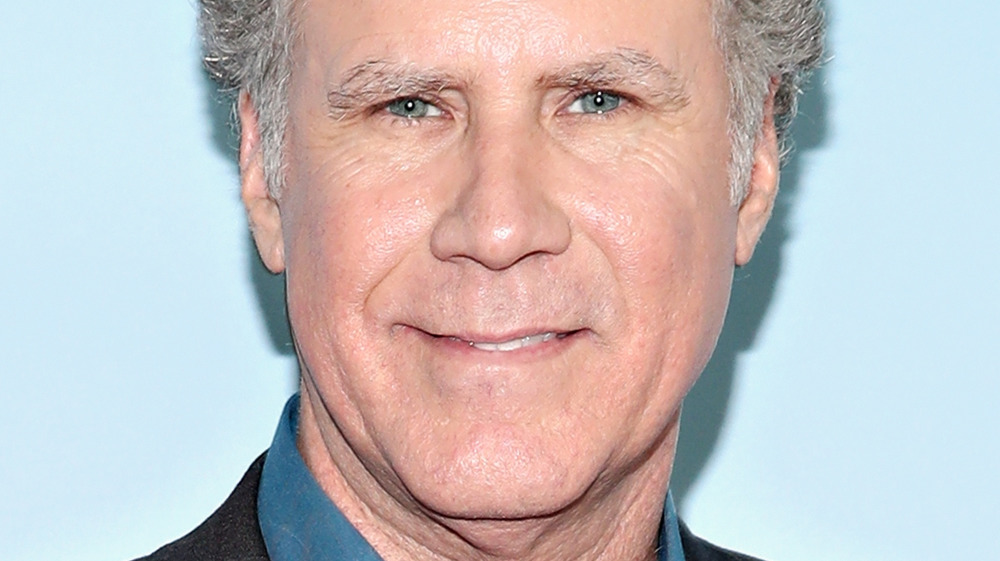 Will Ferrell smirking to cameras