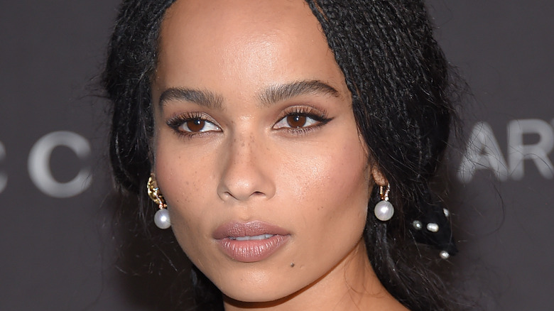 Zoe Kravitz at an event, wearing pearl earrings