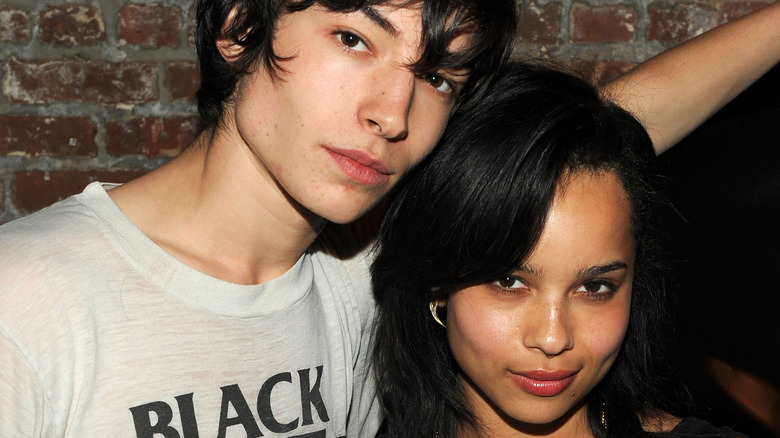Zoe Kravitz and Ezra Miller at an event, being cozy