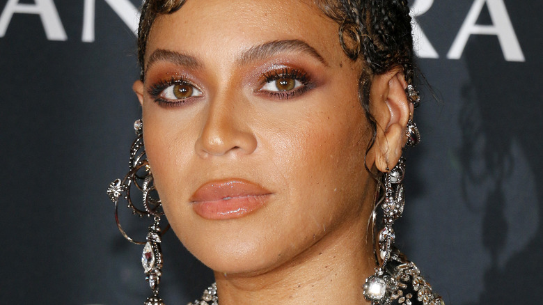 Beyonce on the red carpet with large silver ear jewelry 