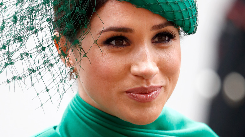 Meghan Markle, the Duchess of Sussex, wearing fascinator with slight smile