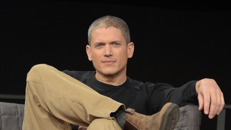 Wentworth Miller sitting in a chair with leg crossed